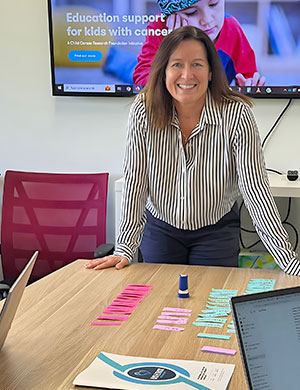 Kylie in front of a presentation screen